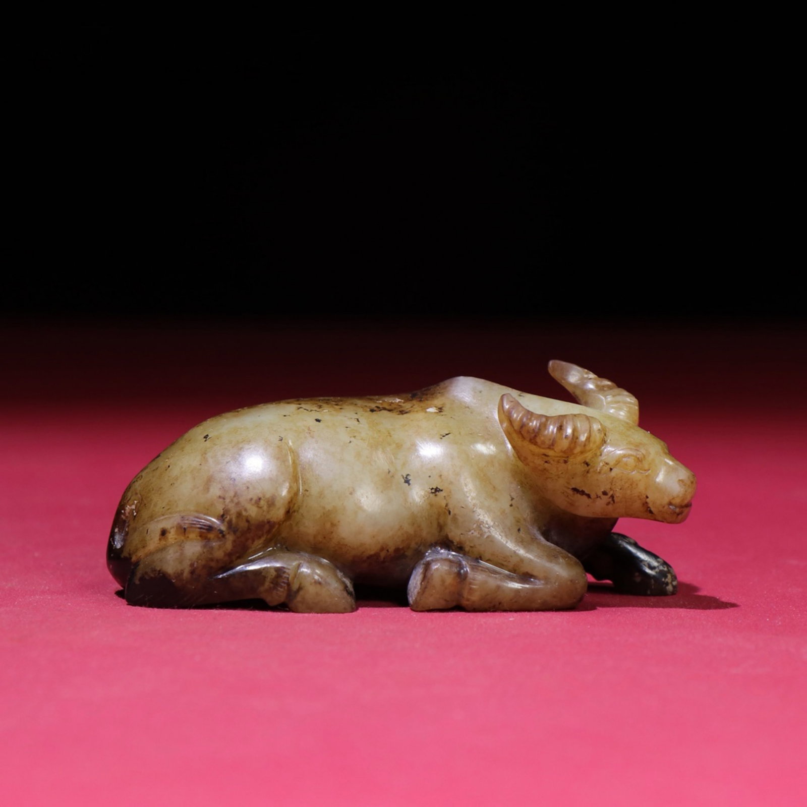 A Chinese Carved Jade Bull Statuette: A Chinese Carved Jade Bull Statuette. Lg. 8.1cm, Wd. 3.4cm, Th. 3.3cm, Wt. 118g