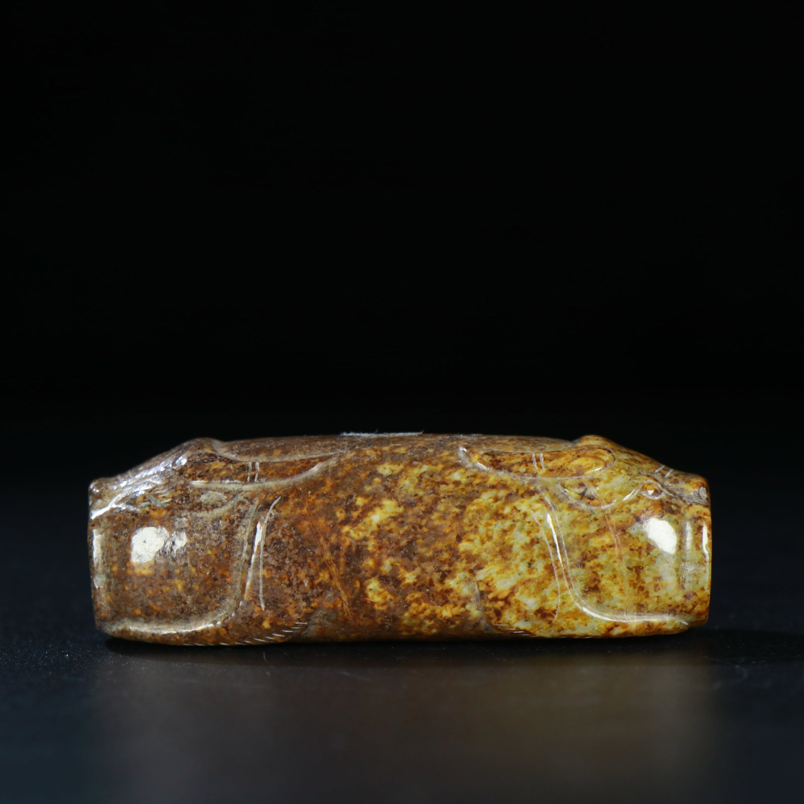 A Chinese Carved Jade Bead: A Chinese Carved Jade Bead. Lg. 6.9cm, Wd. 2.3cm, Ht. 2.2cm, Wt. 70g