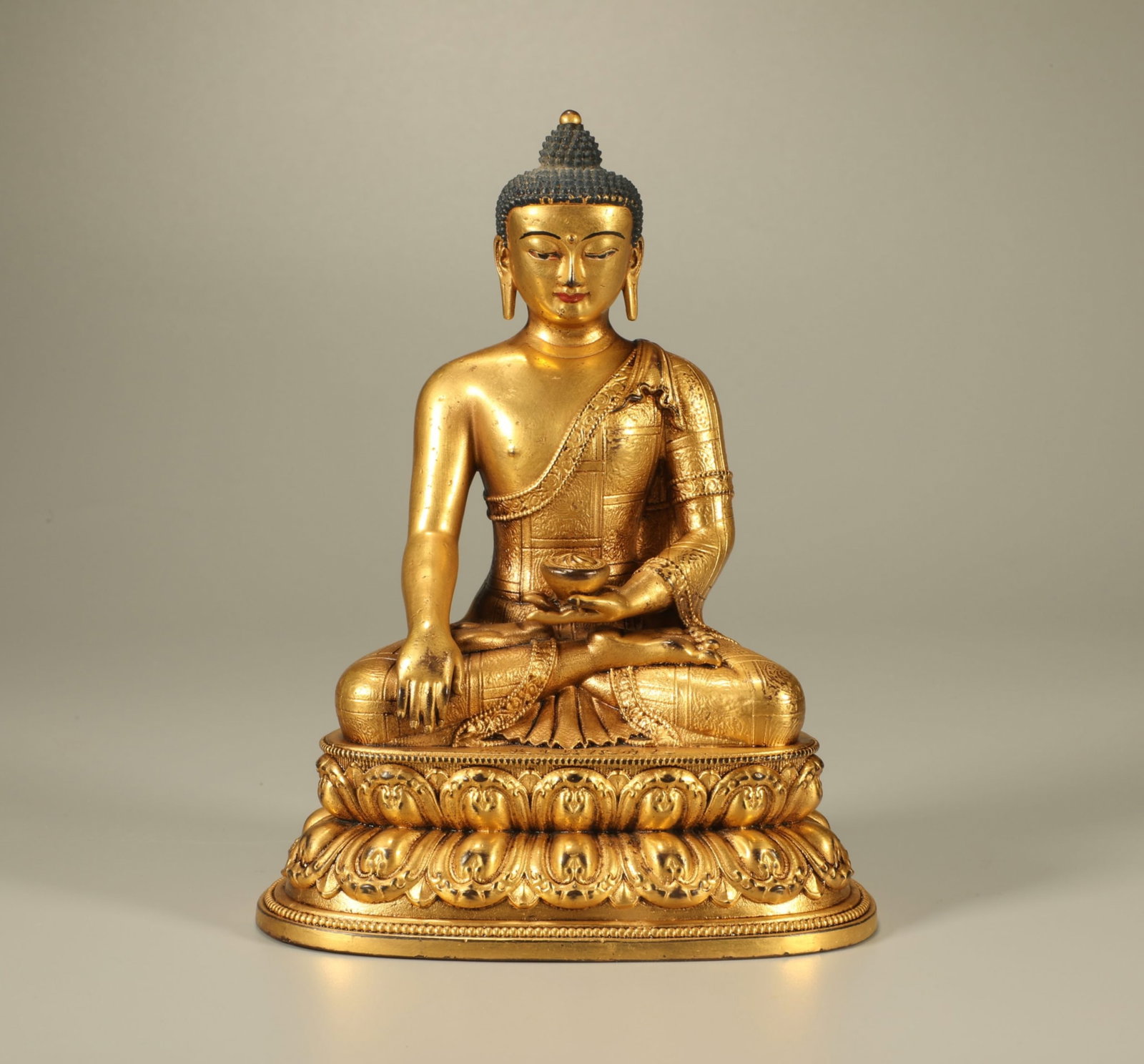 A Chinese Gilt Bronze Figure of Buddha: A Chinese Gilt Bronze Figure of Buddha. Ht. 15.5cm, Wd. 11.7cm, Lg. 8.5cm