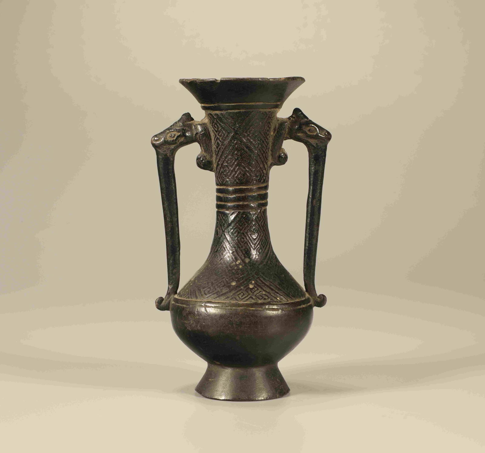 A Chinese Bronze Vase with Double Ears: A Chinese Bronze Vase with Double Ears. Ht. 12.5cm, Wd. 7cm