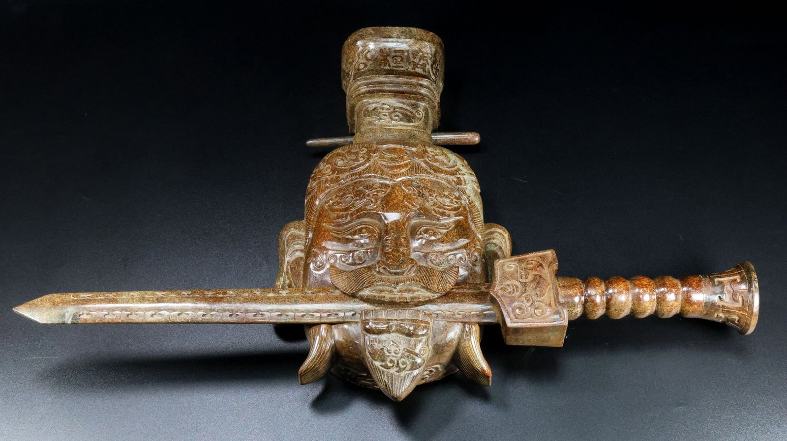 A Chinese Carved Jade Face Mask and Sword Decoration (1 of 9)