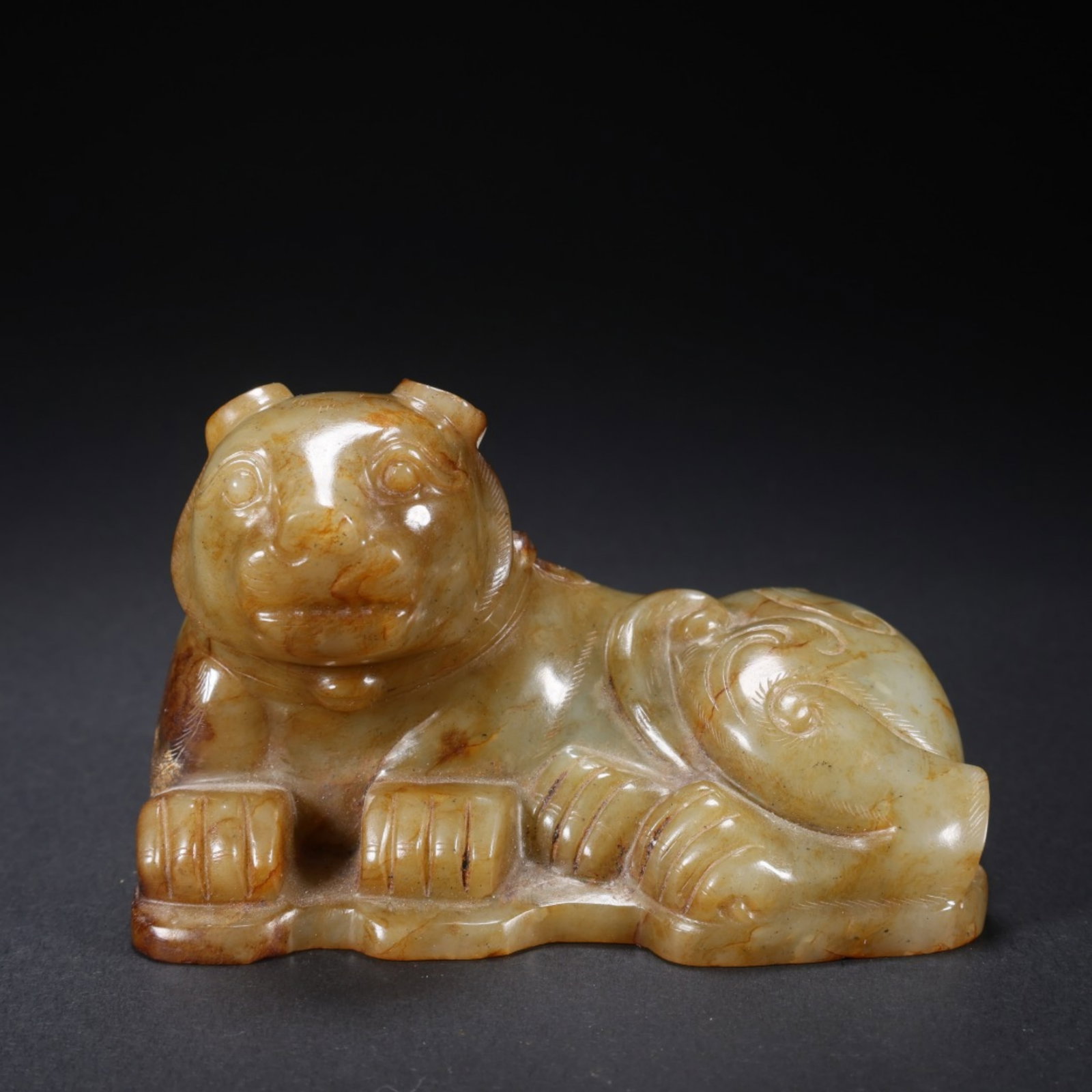 A Chinese Carved Jade Foo-Dog Statuette: A Chinese Carved Jade Foo-Dog Statuette. Lg. 9.4cm, Wd. 6cm, Ht. 5.7cm, Wt. 400g