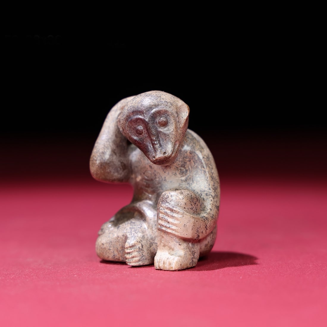 A Chinese Carved Jade Monkey Statuette: A Chinese Carved Jade Monkey Statuette. Ht. 5cm, Wd. 3.8cm, Th. 3.6cm, Wt. 85g