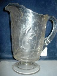 Sandwich glass pitcher with a squirrel in boughs,: Sandwich glass pitcher with a squirrel in boughs, measures 9 1/2" h.