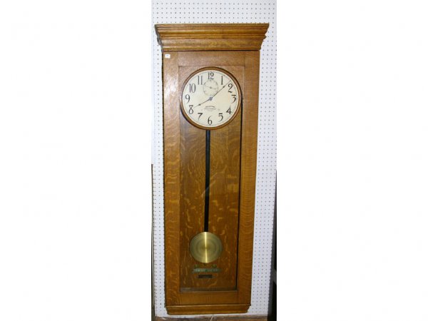 IBM Oak Cased Pendulum Wall Clock: Oak cased, glass front, electric hanging wall clock by IBM. 65" x 20"