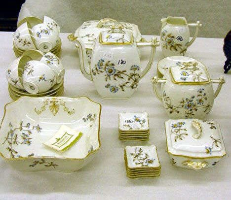 Early Limoges China: Early Limoges China, Floral Pattern with bamboo motif style handles includes: teapot, large creamer, sugar, 2 covered dishes, (1 large another smaller), large open bowl, 8 cups and saucers, 12 butter