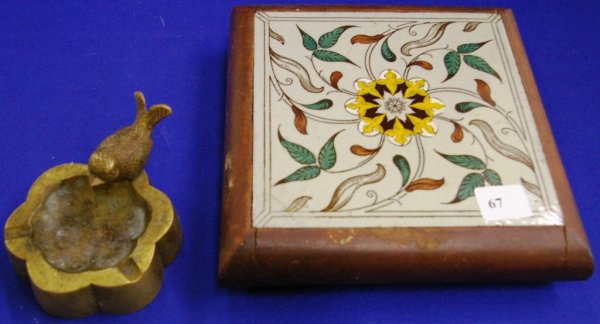 A Hand-painted Tile Trivet And A Brass Ashtray: Hand-painted Tile Trivet, And A Brass Ashtray With Bird Finial Made In India