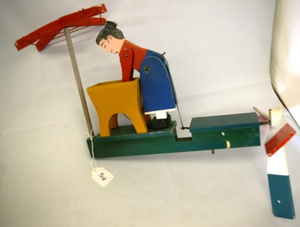 Early Art Deco Whirligig: Note missing one blade. Depicts a woman doing her laundry, measures 15" x 18"