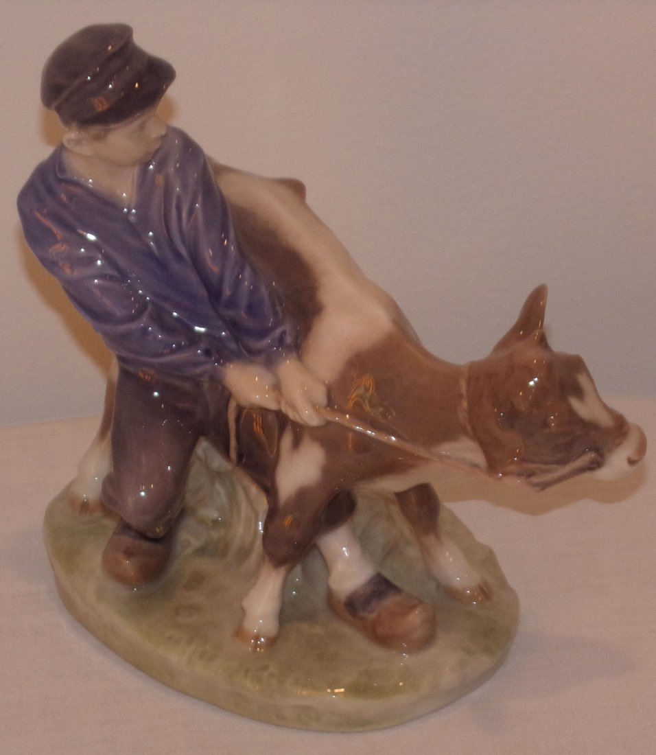 Royal Copenhagen Figure: Royal Copenhagen figurine, young boy holding tightly onto calf, #772, approx. 6 ½” T