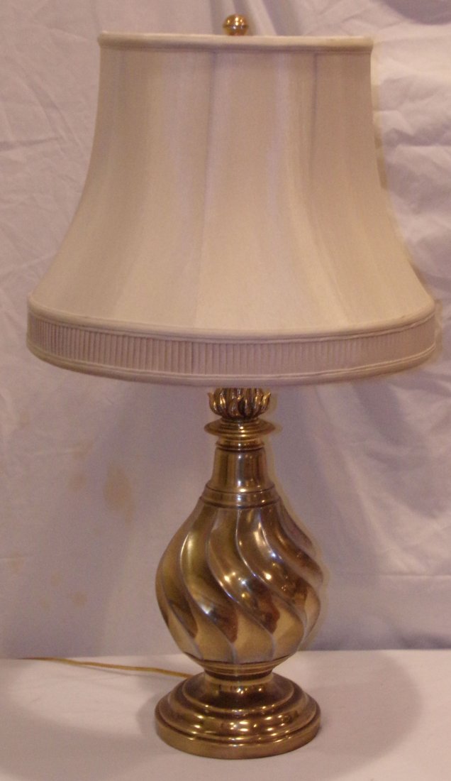 Table Lamp: Modern brass vase form table lamp w/flame top decoration & swirled design by Frederick Cooper, white linen shade, brass finish showing wear, approx. 29" T
