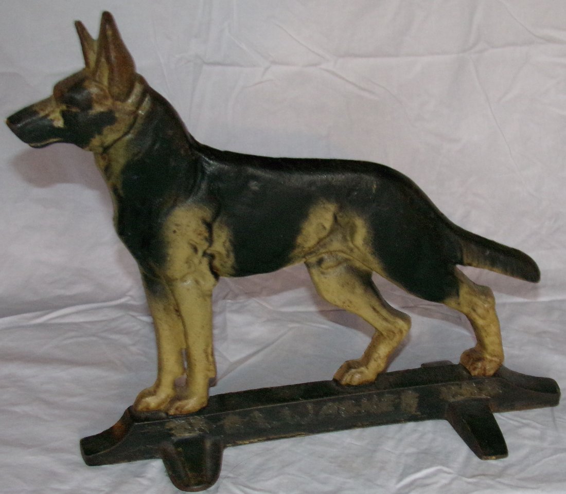 Cast Iron German Shepherd Doorstop: Vintage cast iron German Shepherd dog form doorstop on rectangular base, painted, name scratched into base is not original, 11 ¾” T x 13 1/8’’W x 5 1/8” D
