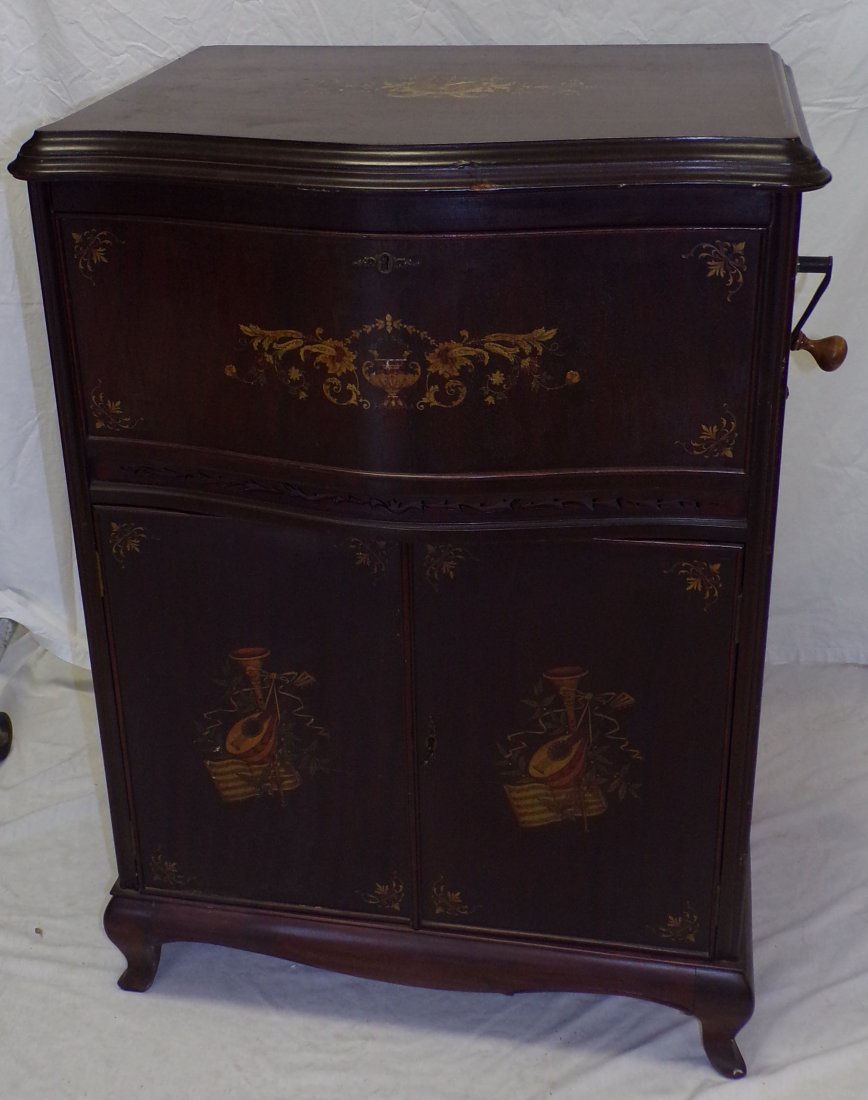 Mira Floor Model Music Box w/ Discs: Mira Floor model mechanical music box which plays round metal discs in mahogany cabinet with painted flower urn, horn, mandolin, floral & leaf design, base has 2 blind doors, opening to slots for disc