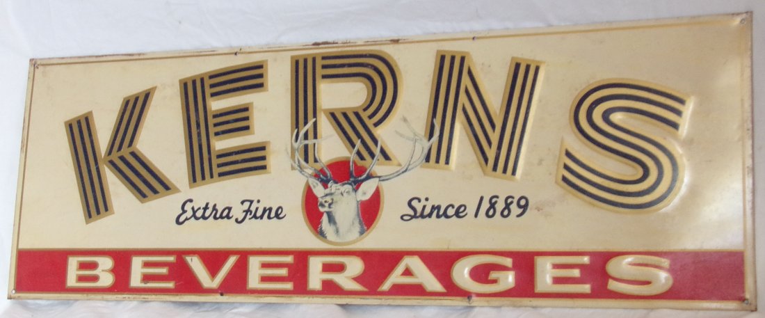 Metal Advertising Sign - Kerns Beverages: Metal advertising sign – Kerns Beverages, Extra Fine Since 1889 w/buck image at center, some paint loss on front rust visible on back, 9 ¼” T x 27 3/8” W