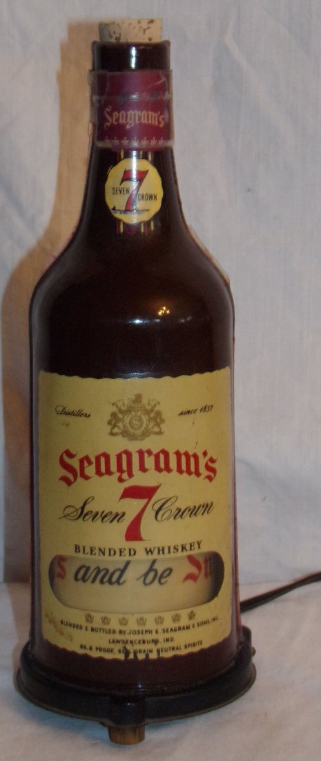 Seagram's Seven Crown Whiskey Bottle Light: Seagram’s Seven Crown Whiskey bottle, made of plastic, electric light, interior advertising logo that rotates, 10 ¼” T x 4” diameter base