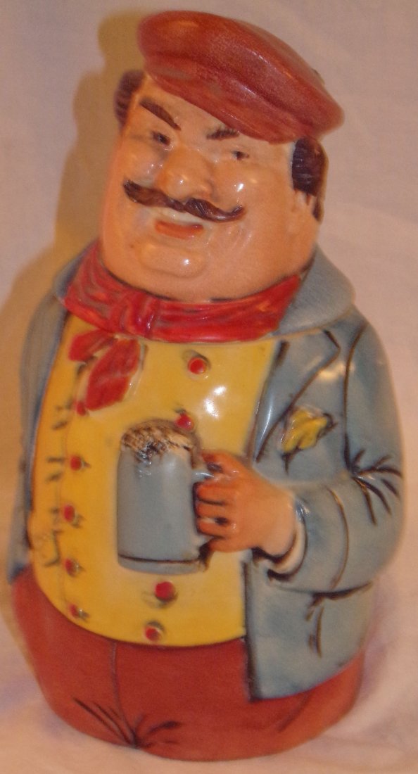Figural Earthenware Beer Stein: Figural earthenware beer stein with lid, portly man holding a beer stein, in blue jacket, marked Western Germany, I/H, 24, 8 ½” x 4 ½” diameter