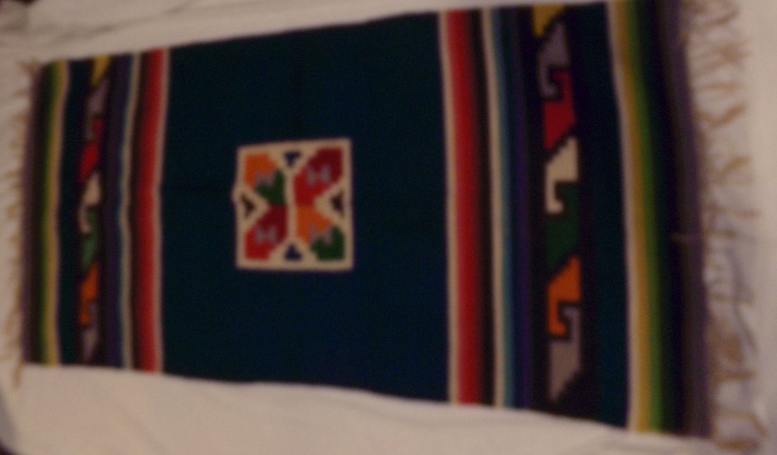 Southwestern / Mexican Area Rug: Southwestern U.S. Native American/Mexican area rug in dark blue field with multiple colors-blue, red, ivory, black, yellow, green, orange & grey, center square design with “H” & “T” symbols, a
