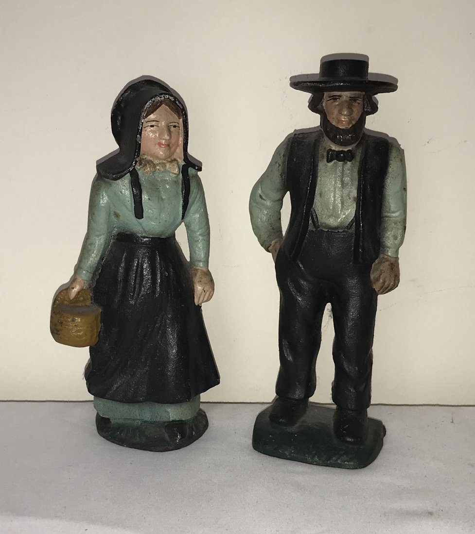 Pair of Cast Iron Figures: Pair of cast iron figures, painted decoration, Amish man & woman; man-9” T x 2 7/8” W x 2 ¼” D; woman-8” T x 2 ½” W x 2 ½” D