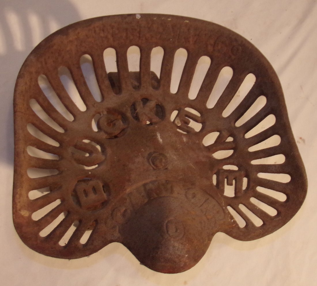 Cast Iron Tractor/Farm Implement Seat: Cast iron tractor/farm implement seat marked Adriance Buckeye, some rust, good condition, 18” w x 15” D