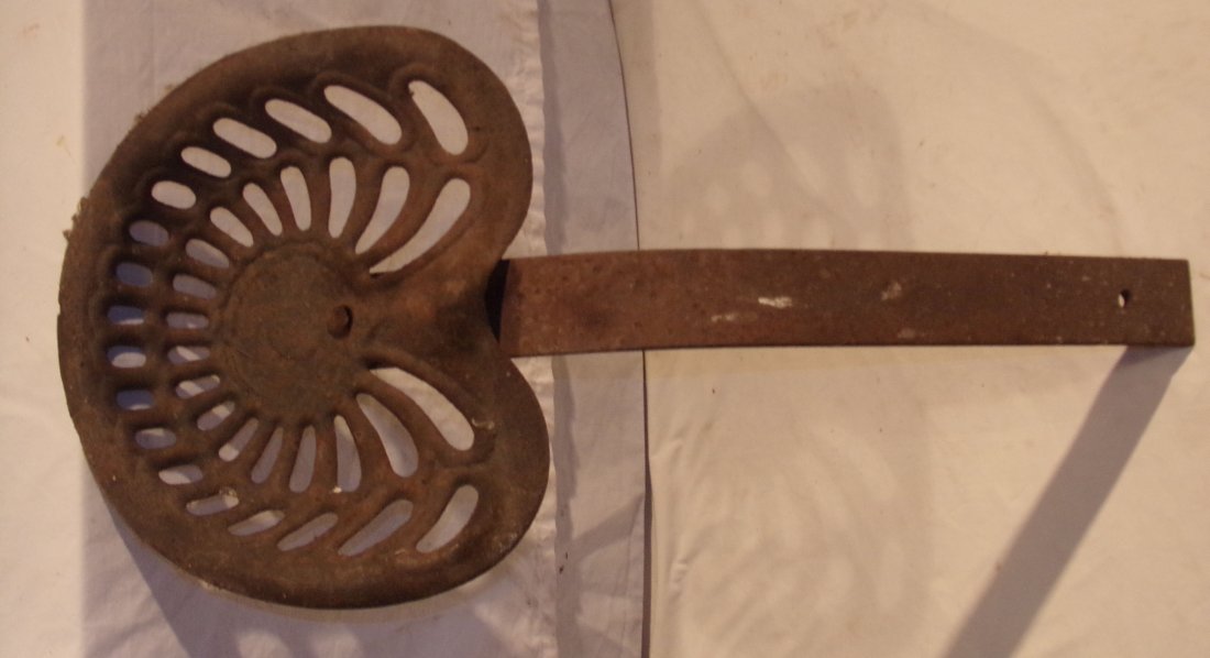 Cast Iron Tractor/Farm Implement Seat: Cast iron tractor/farm implement seat on iron mount, unmarked, rust visible, 17” W x 15” D x mount approximately 25” T