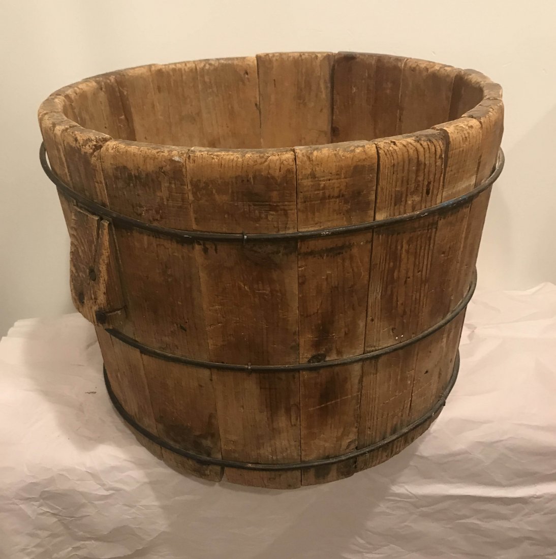 FURNITURE, ACCESSORIES, COUNTRY COLLECTIBLES, TOYS,: Antique primitive country round wooden tub with side handles and wire work staves, original unfinished surface, some old splits and damage visible, 12 ½” T x 13 ¾” diameter