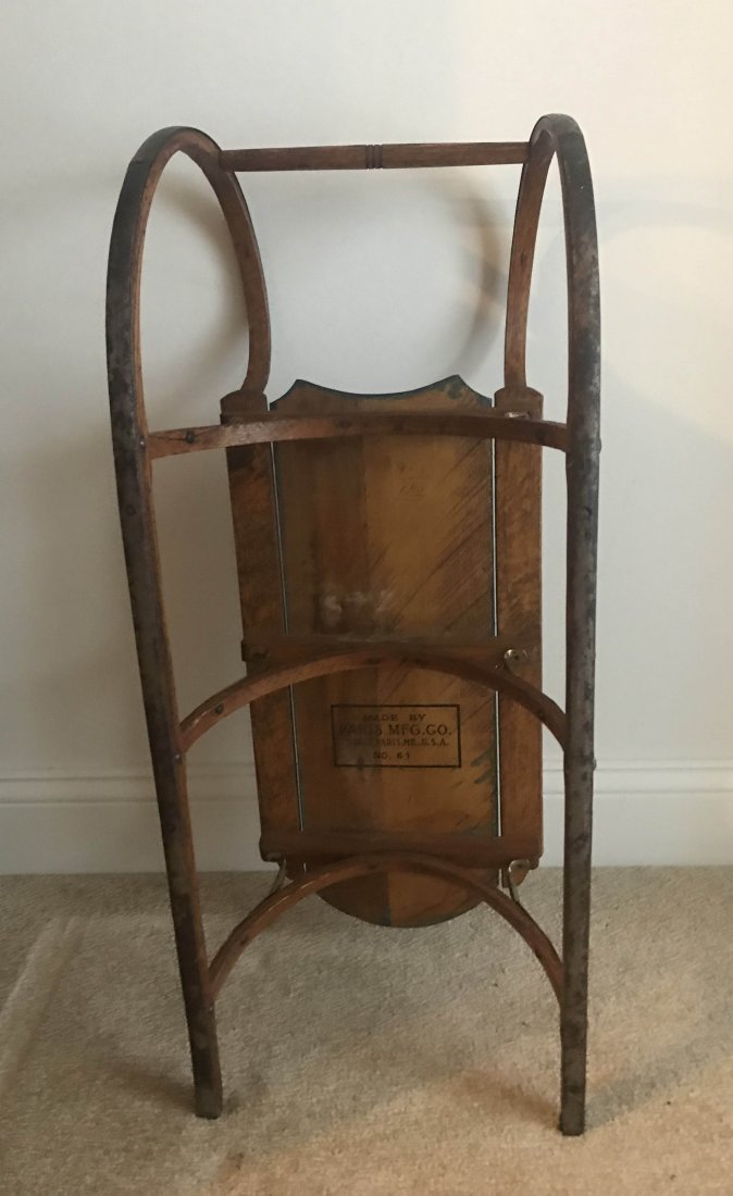 FURNITURE, ACCESSORIES, COUNTRY COLLECTIBLES, TOYS,: Vintage child’s sled in oak and softwood, seat in blue paint with yellow flower petal design, steel mounts, Made By Paris Mfg. Co., South Paris, ME., USA, No. 61, 10 ½” T x 28 ¾” L x 10” W