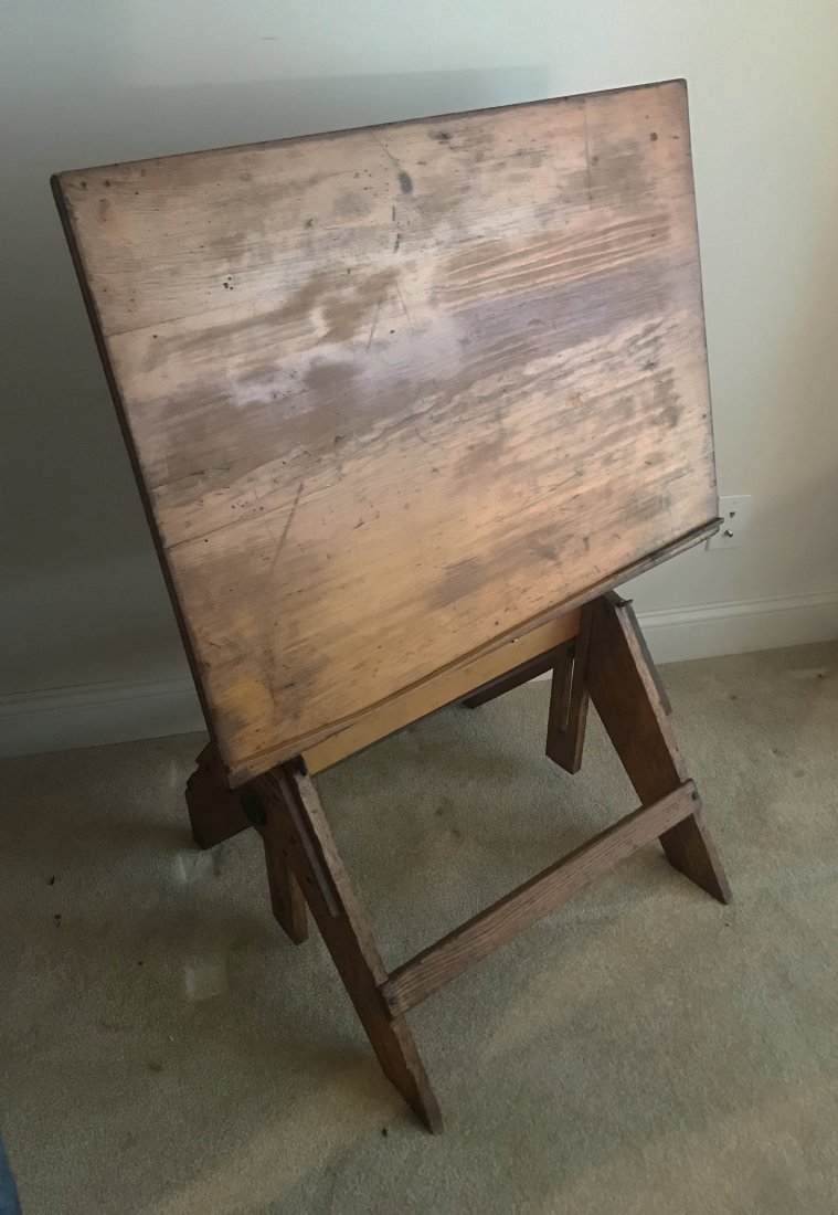 FURNITURE, ACCESSORIES, COUNTRY COLLECTIBLES, TOYS,: Vintage draftsman’s table having an adjustable/swivel top with drawer mounted on a sawbuck style base, mixed woods, 41” T x 30 ¾” W x 23 ¼” D (measurements taken as shown in photo)