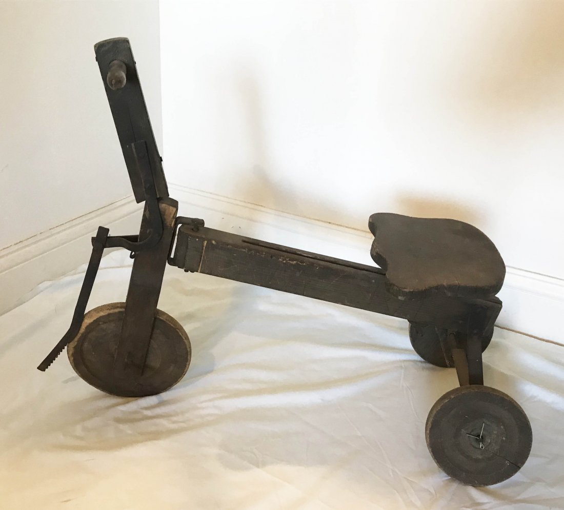 FURNITURE, ACCESSORIES, COUNTRY COLLECTIBLES, TOYS,: Vintage wooden tricycle scooter, wooden frame and wheels with iron steering mechanism and rear axle, old distressed surface with wear, tear and scuffing, 20” T x 26” L x 10 ½” W