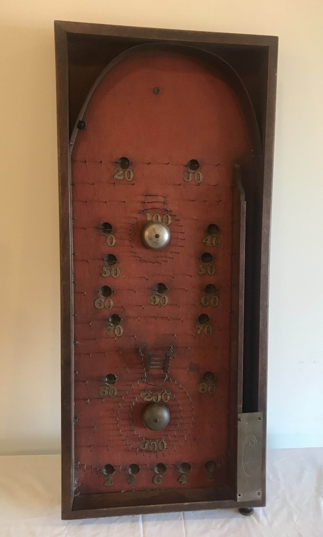 FURNITURE, ACCESSORIES, COUNTRY COLLECTIBLES, TOYS,: Vintage Victorian pinball game w/rectangular walnut molded frame, red interior surface w/numerals, metal pins, hoops and 2 bells, no ball, single folding leg on underside, marked on brass plate M. Red