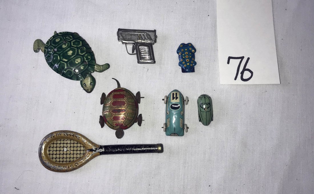 FURNITURE, ACCESSORIES, COUNTRY COLLECTIBLES, TOYS,: Grouping of 7 miniature penny toys: tennis racket; (2) tin turtles on wheels; (2) miniature sports cars; tin pistol; tin frog noise maker
