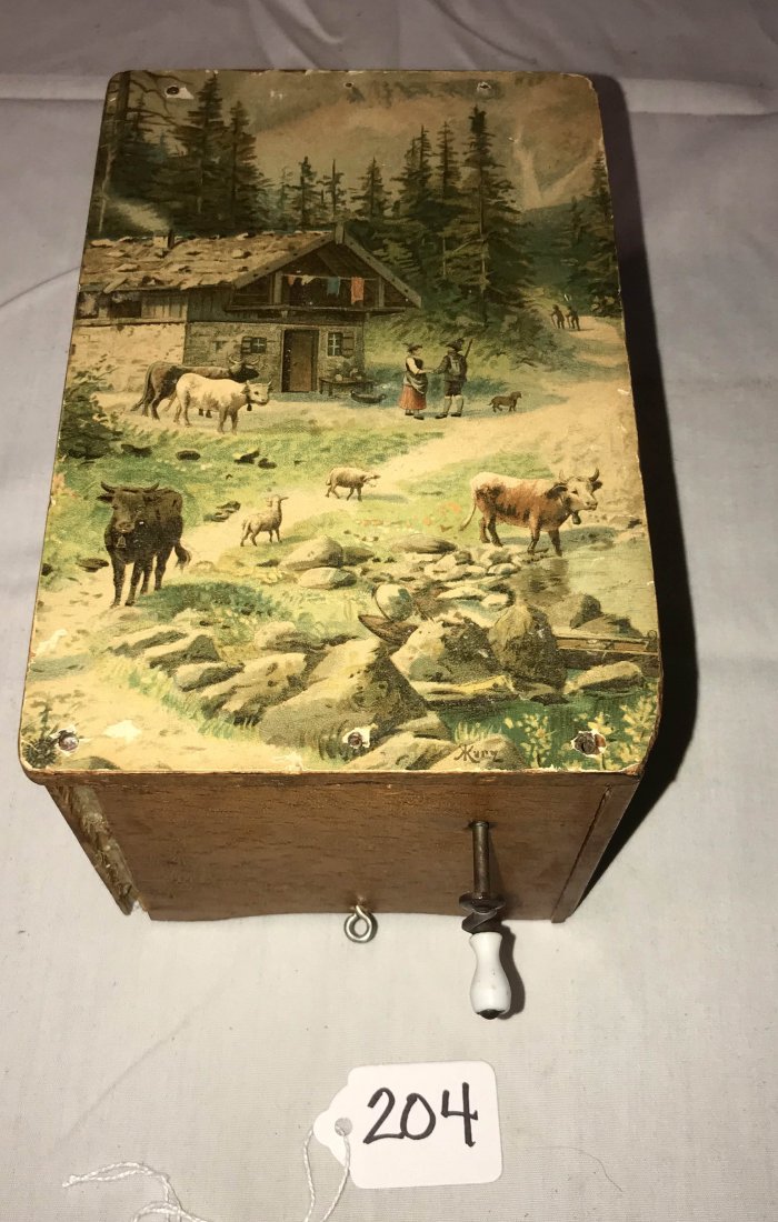 FURNITURE, ACCESSORIES, COUNTRY COLLECTIBLES, TOYS,: 19th century softwood child's music box, the top w/a paper decal, landscape farmyard scene marked Kurz, crank mechanism plays 3 tunes, base paper label w/writing in script identifying the tunes, 4 1/8