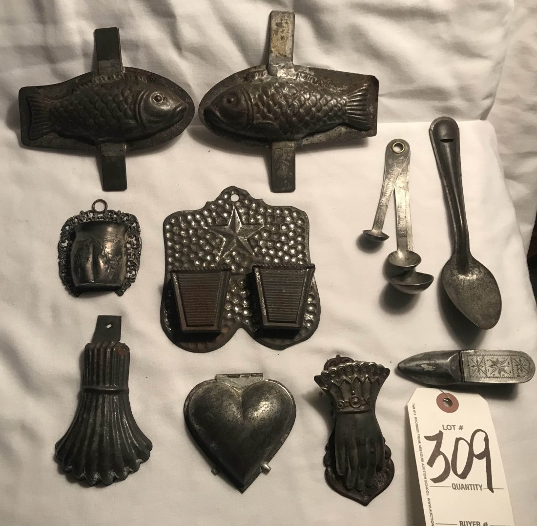 HANDCRAFTED JEWELRY, STERLING AND PLATED SILVER,: Grouping of 9 tin/metal pieces: 2 fish mold (not attached) showing rust, both approx. 5 3/8" L; tin double match holder w/punch and star design, showing rust. 5" x 4 1/2"; heart shaped mold w/initial 