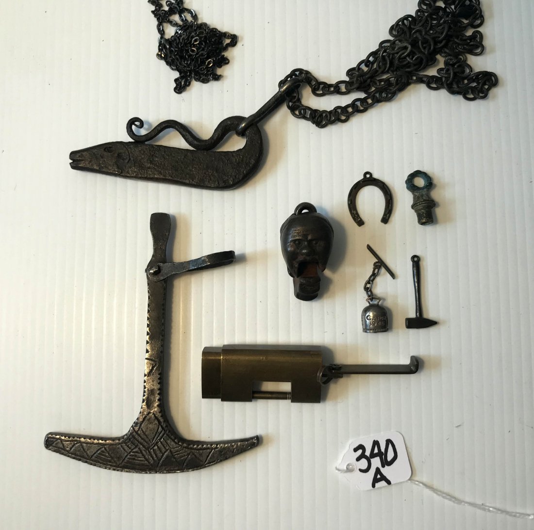 HANDCRAFTED JEWELRY, STERLING AND PLATED SILVER,: Group of iron, brass and other metal objects: unusual cast iron pendant, human head w/mouth opening and closing, Pat, '76, 1 3/4" T; primitve iron snake/serpent figure made into pendant w/chain, 3 3/4