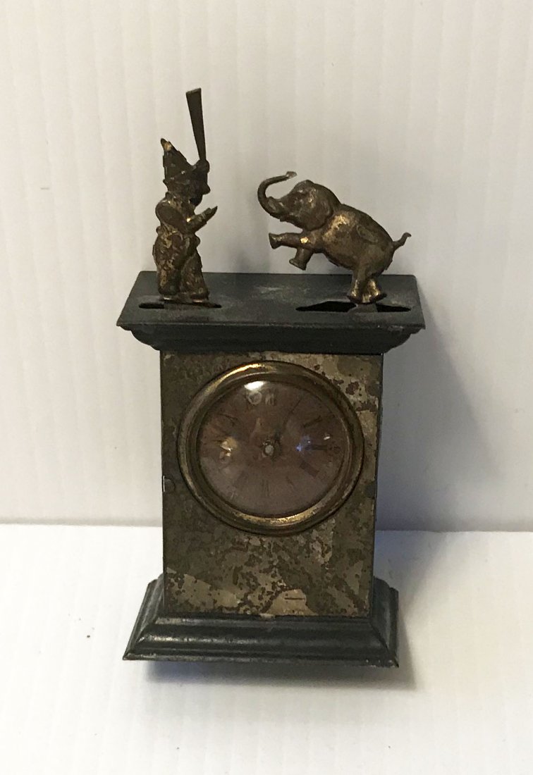 HANDCRAFTED JEWELRY, STERLING AND PLATED SILVER, CLOCKS: Vintage tin miniature automaton clock w/trainer and elephant figures moving on top of case, case shows surface rust, wear and paint loss throughout, approx. 4" T x 2" W x 1 1/4" D