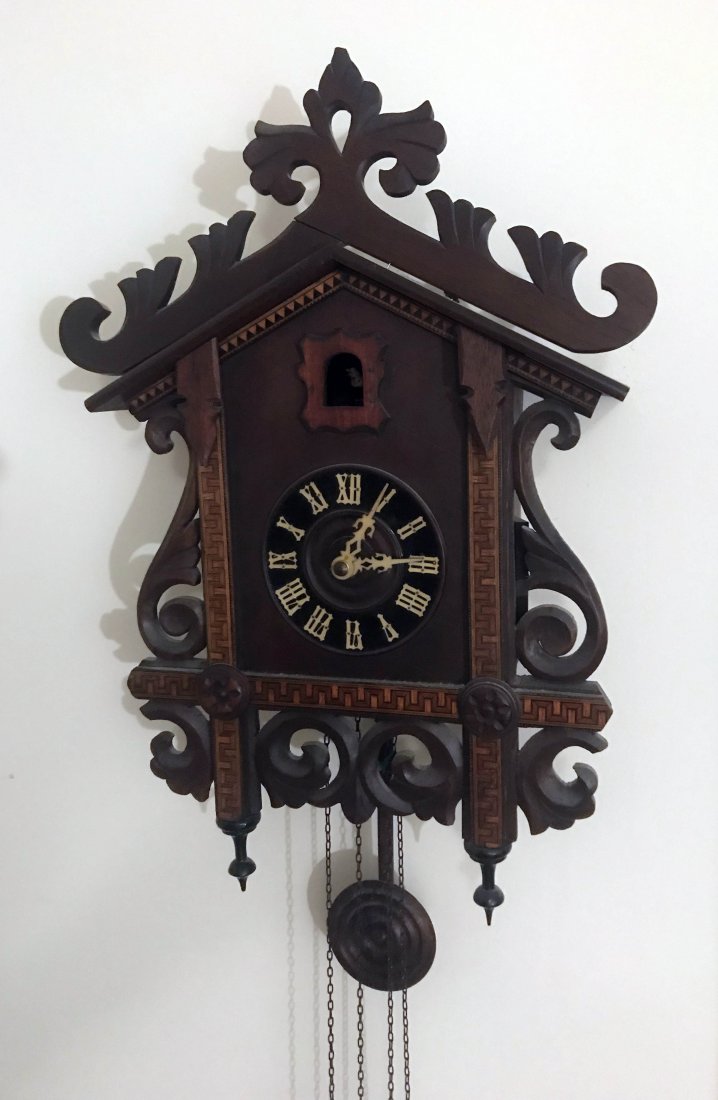HANDCRAFTED JEWELRY, STERLING AND PLATED SILVER, CLOCKS: Cuckoo clock having gingerbread top, sides and base with inlay design and 2 inverted finials, pendulum and 2 weights, 25Â” T (to base of pendulum) x 14 ½Â” x 4 ¾Â” D