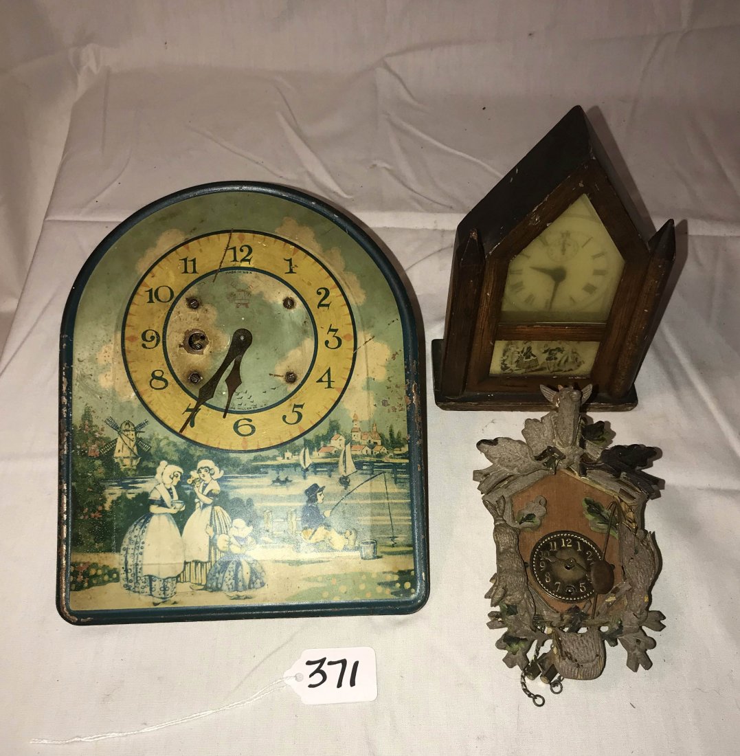 HANDCRAFTED JEWELRY, STERLING AND PLATED SILVER, CLOCKS: Grouping of 3 clocks: a tin hanging kitchen clock w/blue and white Dutch wiindmill design, Made In USA, shows scratches and surface wear, no key, 9" T; wooden steeple form alarm clock by Burroughs; AN