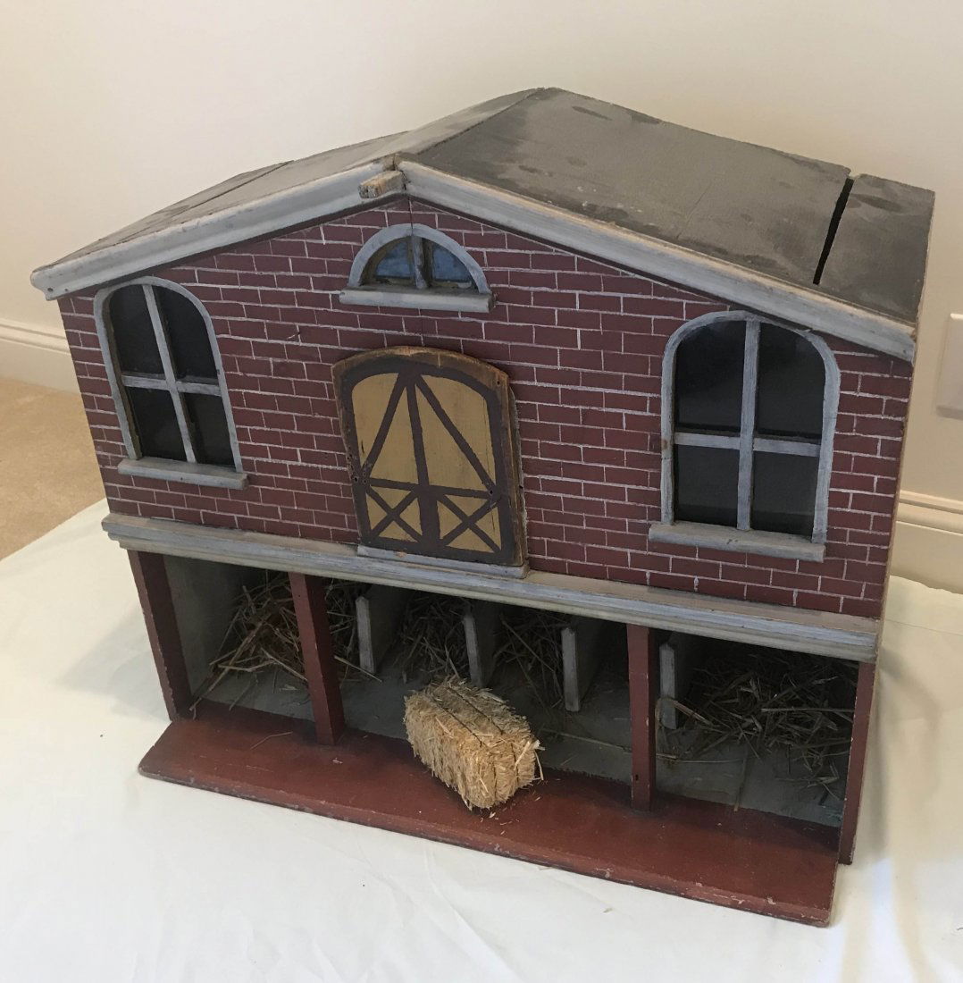 DOLLHOUSE, DOLLS, MINIATURES: Doll size 2 story barn/stable building, peaked roof w/painted brick siding, lower level w/3 animal stalls, upper level w/arched door and 3 arched windows, painted red, white and black, old surface wea