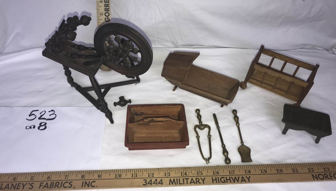 DOLLHOUSES, DOLLS, MINIATURES: Grouping of dollhouse furniture: wooden cradle w/hood; wooden crib on wheels-marked on bottom Made in Bermany; (3) brass fireplace tools-poker, shovel, tongs; small stool in dark brown paint; dollsize