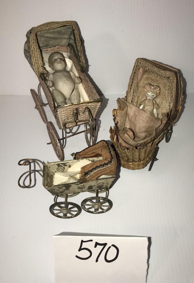 DOLLHOUSE, DOLLS, MINIATURES: 3 doll carriages and contents including: tin carriage with Â“wovenÂ” design, folding cloth hood in blue floral design/lace trim, carriage and wheels painted pink/beige, paint peeling on bottom o
