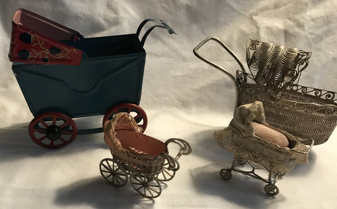 DOLLHOUSES, DOLLS, MINIATURES: Group of 4 miniature doll carriages including: an unmarked blue tin with movable red hood with floral design, tin interior having a molded pillow, bedding with litho design matching hood, condition-ex