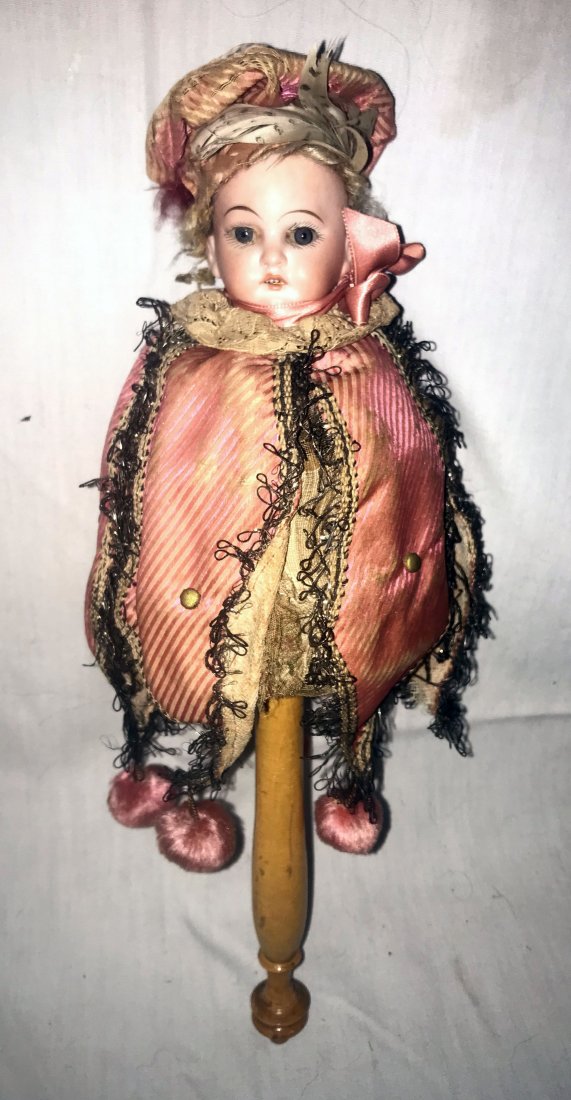 DOLLHOUSE, DOLLS, MINIATURES: Antique bisque head twirling musical doll on turned wooden handle, marked 3200.AM 9/0 DEP Germany, original jester costume, fixed glass eyes, body is a music box w/turning handle that enables it to pl