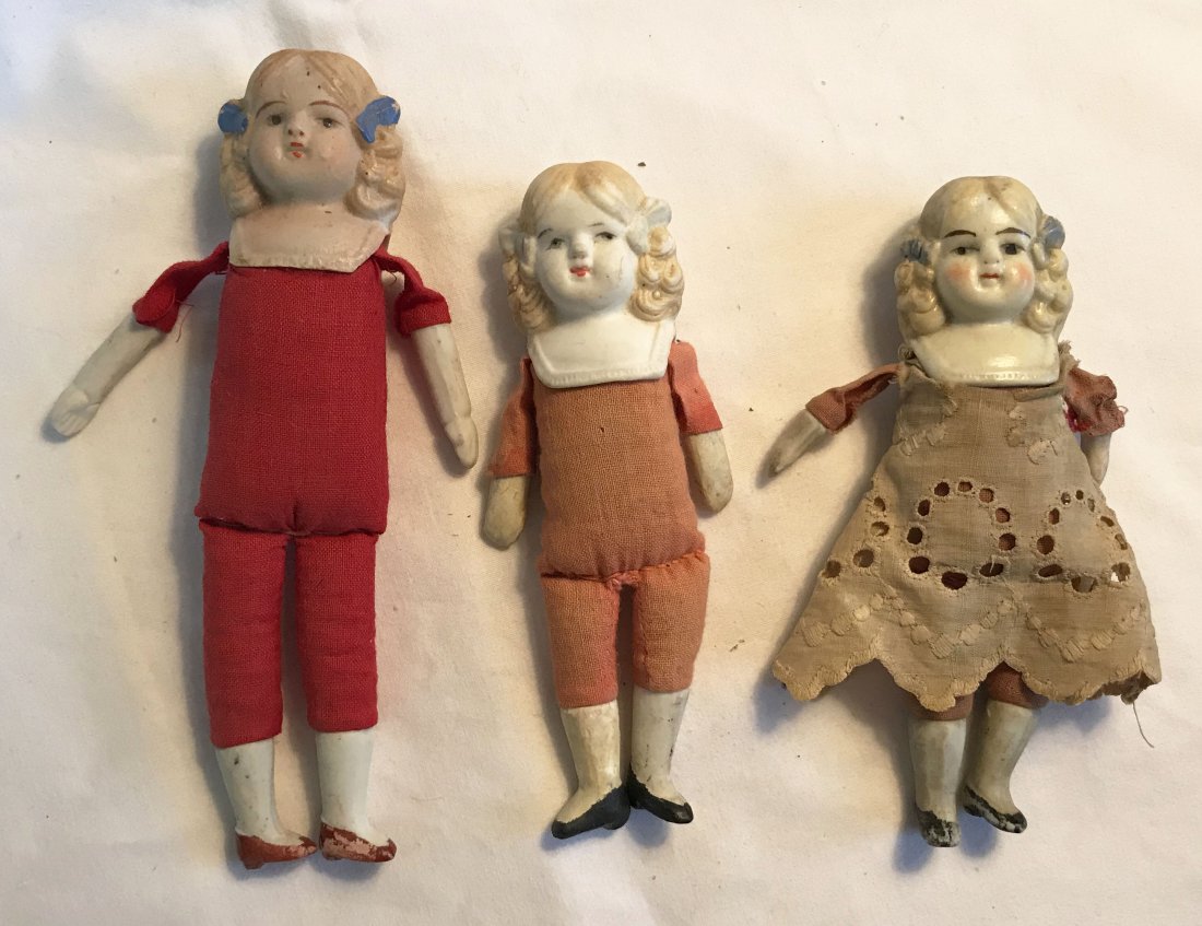 DOLLHOUSE, DOLLS, MINIATURES: 3 bisque/china head dolls with bisque arms and legs, cloth bodies, all with molded hair: (1) signed Nippon, red cloth body, head/breast plate-1 ¾”, overall 6 ¼” T; (2) unmarked, faded cloth body