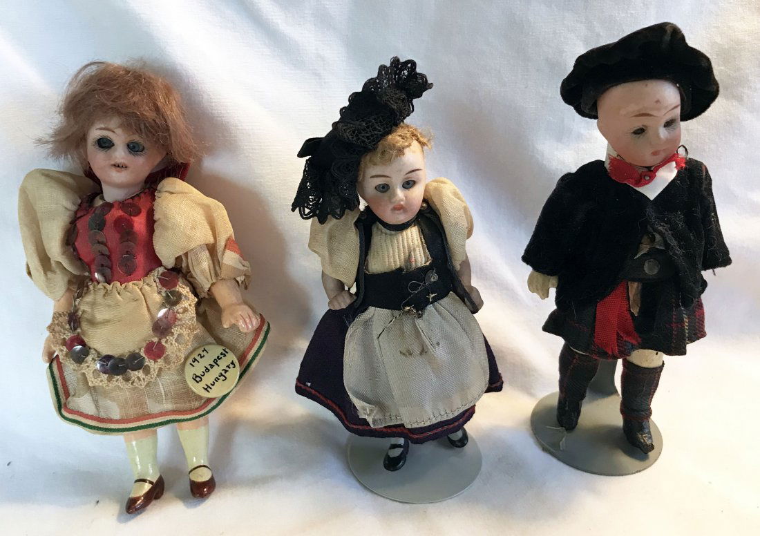 DOLLHOUSE, DOLLS, MINIATURES: 3 porcelain/bisque heads: girl w/sleeping blue glass eyes, open mouth with teeth, composition hands and feet, marked Germany 120 with William Goebel crown symbol, auburn wig, tradition Hungary outfit,