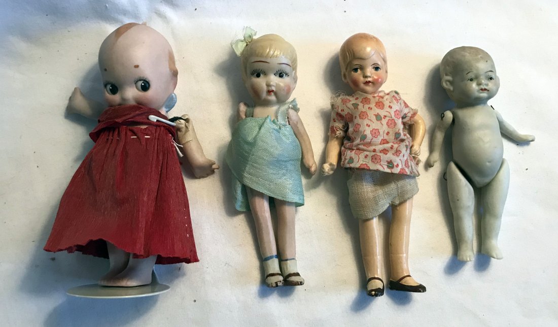 DOLLHOUSE, DOLLS, MINIATURES: Group of 4 dolls all with handpainted features: bisque kewpie with blue wings, crepe paper dress, chip on hair, arms need string tightened, 5 ¼” T; bisque marked made in Japan, molded hair with att