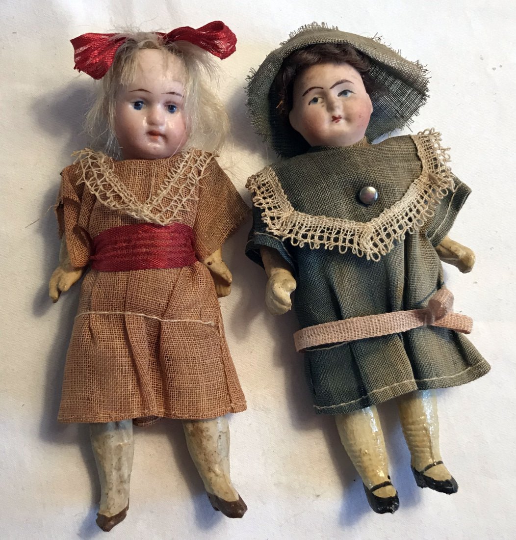 DOLLHOUSE, DOLLS, MINIATURES: 2 bisque/porcelain head dolls both with handpainted features, composition arms and legs: (1) original dress, marked 23 Germany, wig AS IS, 3 ¾” T; (2) sun fading to blue outfit, wig unattached, sig