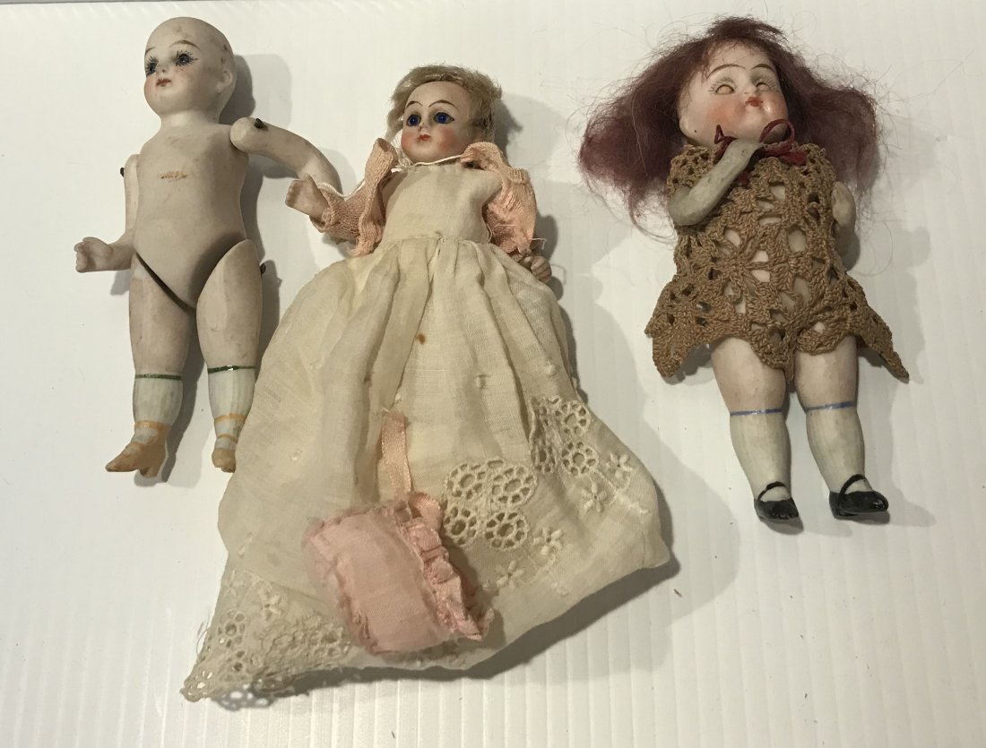 DOLLHOUSE, DOLLS, MINIATURES: Group of 3 bisque/porcelain dolls: painted face, no hair, jointed body, marked 5037I, painted socks/shoes, unclothed, 5" T; handpainted face, wig shows wear, jointed arms, portion of shoe missing, cot