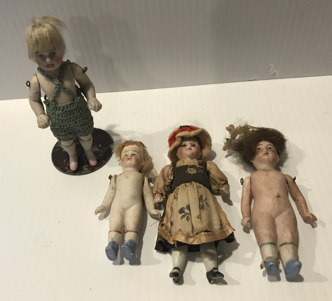 DOLLHOUSE, DOLLS, MINIATURES: Group of 4 miniature bisque/porcelain dolls, all w/handpainted features: 1 w/jointed arms, blonde hair-thinning in green crocheted shorts, pink painted shoes, 4"; 1 w/jointed arms, painted socks/shoes