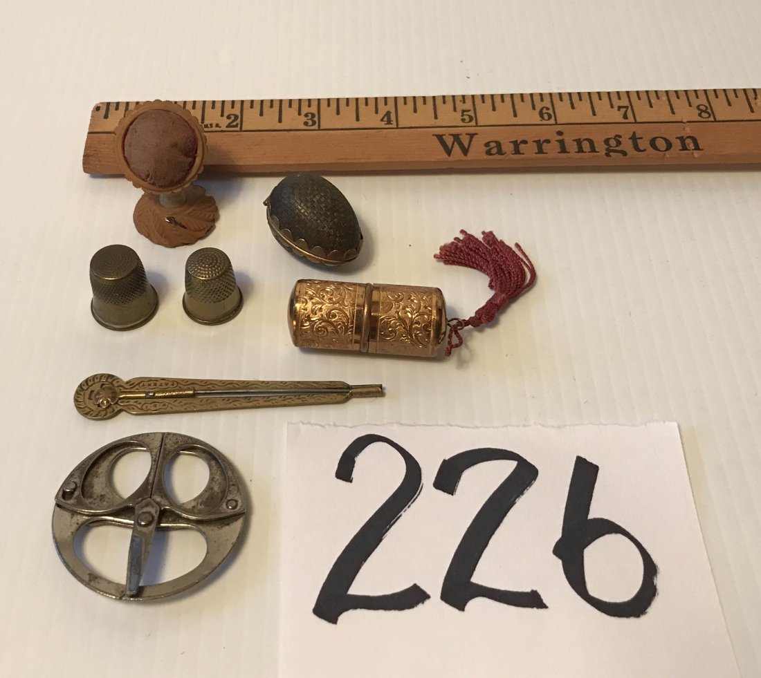 FURNITURE, ACCESSORIES, COUNTRY COLLECTIBLES, TOYS, ETC: Group of sewing items: folding scissors/shoe hook marked Hesjah Trade Mark, gold tone thread holder w/ornate design, (2) thimbles, thimble egg form case w/woven cover, tatting hook, pin cushion on car