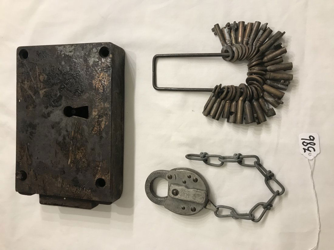 HANDCRAFTED JEWELRY, STERLING AND PLATED SILVER, CLOCKS: Large antique steel lock set, NO KEY, 6" T x 8 1/2" W z 1 3/4" D; AND PRR (Pennsylvania Railroad) pad lock w/chain, NO KEY; AND a collection of approximately 28 brass lock keys on a rectangular metal