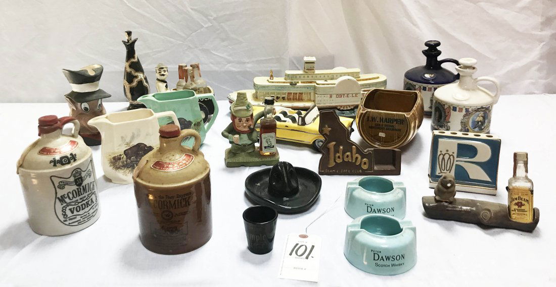 Grouping of Figural Bottles/Decanters: Approximately 40 bottles/decanters: Beam, Harper, Dawson (2) McCormick jugs, (2) Jim Beam, Mr. Lucky, fox pitcher, rum carioca (L), paddle boat-part missing, (2) Peter Dawson ashtrays, Jim Beam Oregon