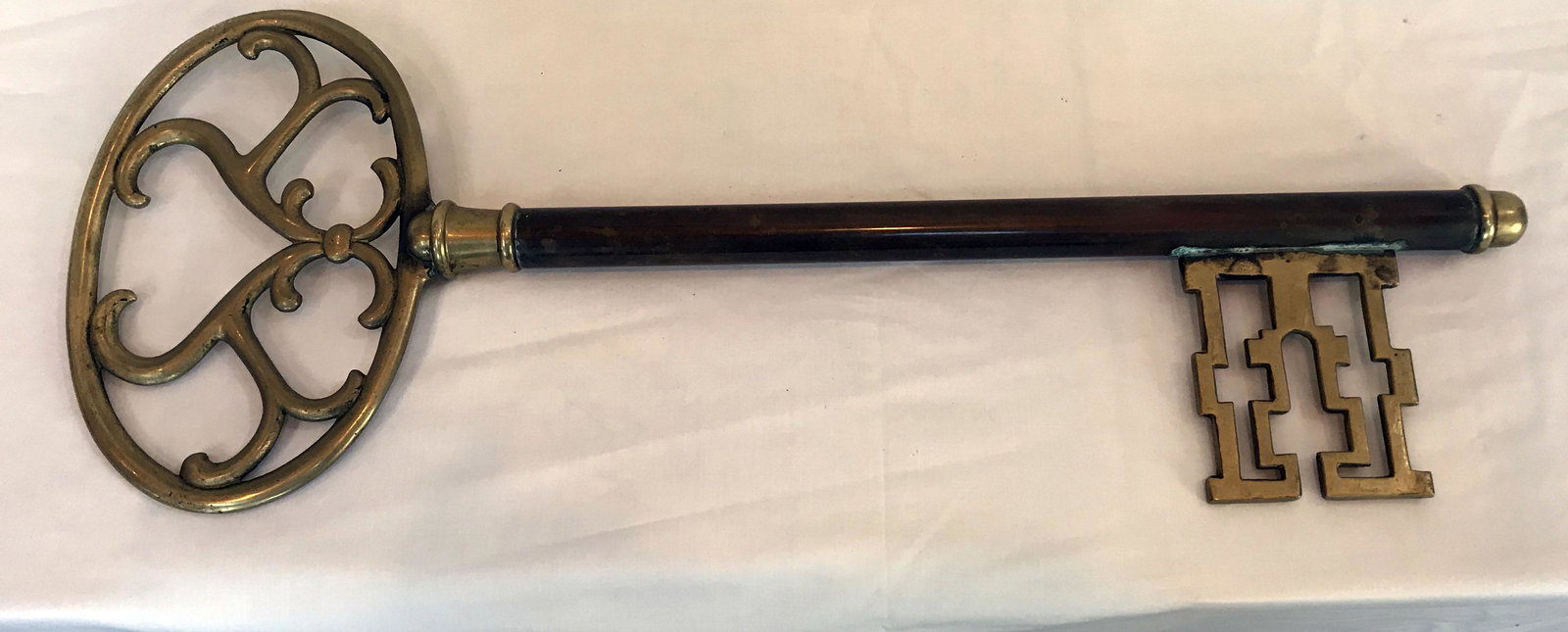 Decorative Key: Large brass decorative key, oval handle, ornate decorative knob end; 30" L x 11" W (handle); locating mechanism, 5 1/8"